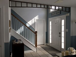Entrance with stairs and first floor master bedroom door