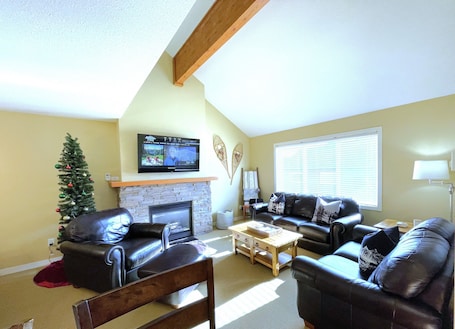 Cozy living room with gas fireplace and deep leather seating