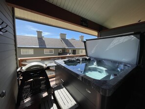 Deck with private hot tub and BBQ.