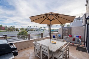 Equipped with a barbecue grill, ample seating, and a dining table, it provides an ideal setting for al fresco dining and relaxation with scenic ocean views in the background. Outdoor living is steps from the kitchen area.