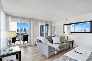 Living area with balcony access and entry into 2nd bedroom suite