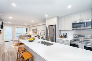 Bright counters and cabinets lend to the open space and good feeling in this unit.