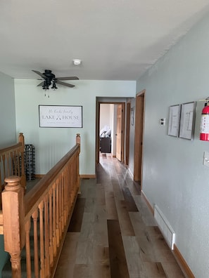 Hallway leading to bedrooms, laundry room and bathroom