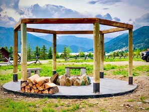 Fire pit with pergola. Fairy lights light up at night. 