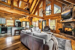 Wide open concept living area with high ceilings and natural light