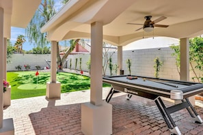 Covered outdoor pool table and entertainment zone