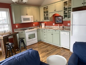 Eat in kitchen features a moveable table with 4 bar stools.