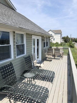 1st floor gated front deck with seating areas.