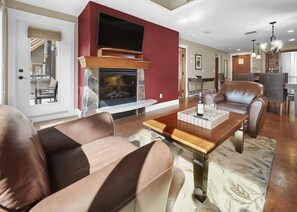 Spacious living room with gas fireplace and television