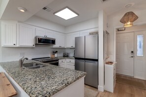 The kitchen has new stainless steel appliances.