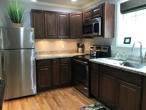 Refrigerator/freezer, microwave and electric range.