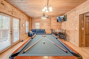 Game Room with pool table, arcade game and TV. Leads to a deck outside with porch swing where you can relax and enjoy the fresh air.