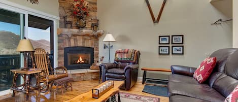 Powderwood Condos 13X: Cozy ambiance with fireplace, perfect for relaxing by the window.