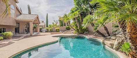 Clean, sparkling, outdoor pool with water feature. Pool games available