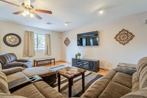 Spacious living room with TV and backyard view