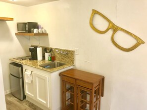 Kitchenette is equipped with Keurig, microwave, 2 burner stove top, basic cooking needs and large sink. A two person folding table is perfect for working or dining. 