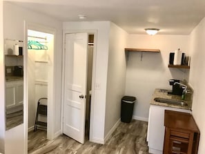 Full sized wall mirror, closet with hangars and luggage rack, full sized bath and kitchenette.