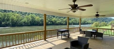 Large covered deck with two ceiling fans. 