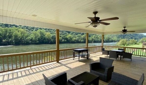 Large covered deck with two ceiling fans. 