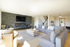 Large living room smart TV with Netflix and Youtube TV.