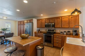 Kitchen with new stainless appliances.