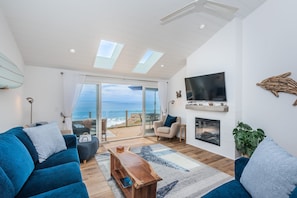 Oceanfront living room with cozy fireplace