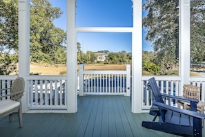 Coast Cottages Marsh View Front Porch - Relax on the Coast Cottages front porch with peaceful views of the marsh and salty breezes from East Beach—just steps from private beach access and island trails.