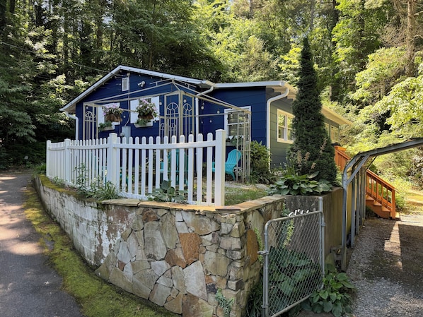 The front of the house offers a cozy fire pit and welcoming string lights.
