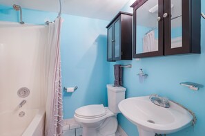 Full bathroom with cabinets and tub/shower