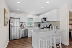 Upgraded kitchen w counter height bar stools and brand new stainless appliances