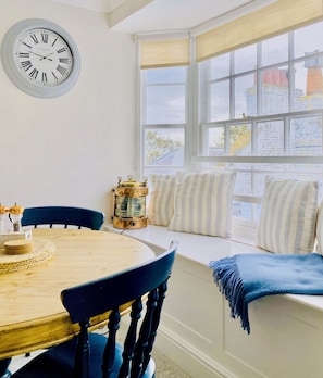 Bay window seat with dining table and chairs with views of Viking Bay