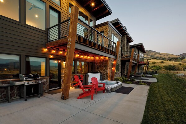 Hot tub and grill in the back of the property downstairs level