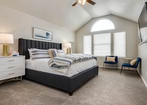 Master bedroom with king bed and TV