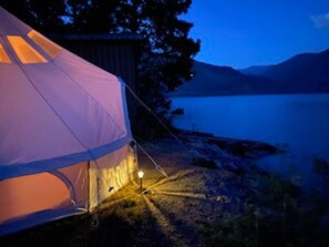 The bell tent sits at the water's edge on Lake Pend Oreille