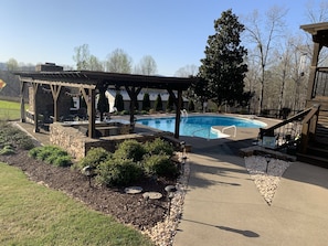 View walking to outdoor living area and pool.