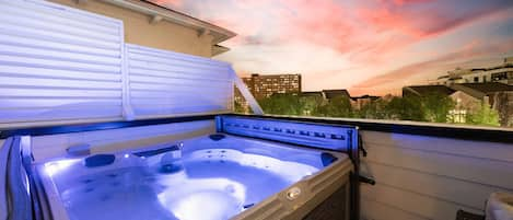 Incredible rooftop patio with hot tub, lounge area, and amazing views of downtown. Includes smart TV and double sided fireplace.