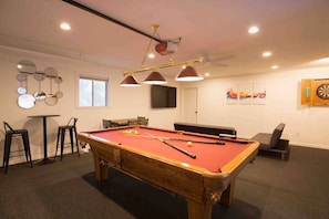 Game room! Yes, that's a regulation sized 8' pool table! Yes that's a brand new big screen TV with plenty of seating! Yes that's a tournament edition dart board!