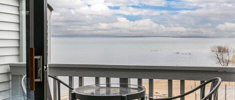 Gazing outward from within the unit, the balcony offers a captivating view of the serene beach.