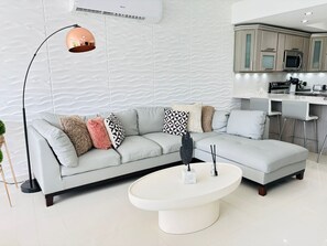 Open living room with lounge sofa and stylish coffee table
