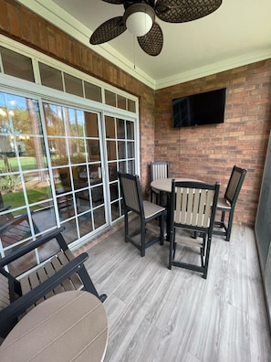 Relaxing first floor screen porch with TV, ceiling fan and golf course access!