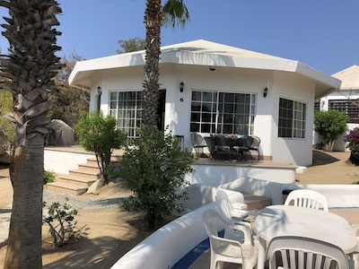 Gorgeous house in a neighbourhood surrounded by palm trees.