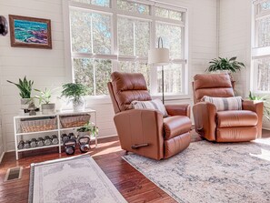 The sitting porch has 2 new leather recliners, a 55" TV and small workout area. 