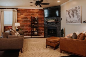 The cozy living room features a gas fireplace and smart tv.
