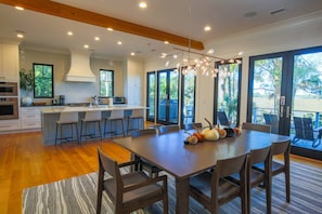 The dining table seats 8 people and there are 4 stools at the kitchen island.