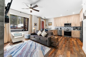 Spacious living area featuring a flat screen TV, gas fireplace, a queen size Murphy bed and a queen pull out sofa.