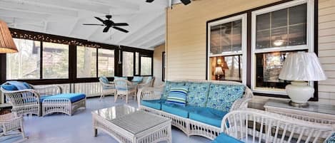 spacious, screened-in porch with dining table and lots of seats