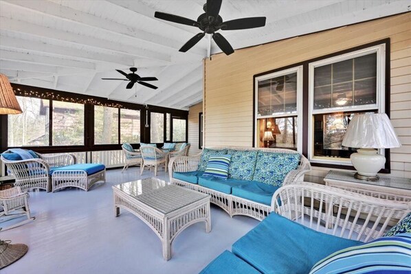 spacious, screened-in porch with dining table and lots of seats