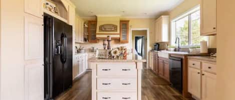 A large kitchen equipped with a 6 burner gas stove to enjoy cooking and baking!