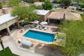 [Resort Property] Backyard heated pool and spa with sun loungers, gas fire pit, and covered patio
