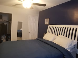 master bedroom with closet and half bath